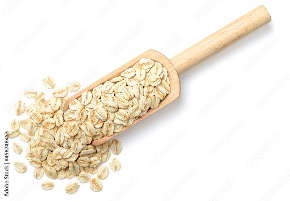 Sticker uncooked oatmeal in the wooden spoon, isolated on white, top view