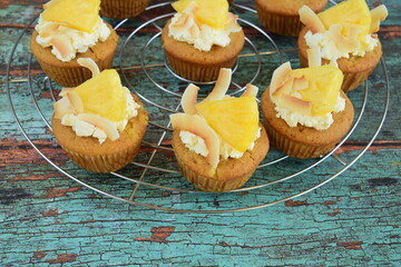 Pineapple coconut cupcakes on cooling rack