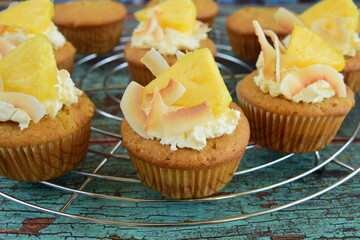 Pineapple coconut cupcakes on cooling rack