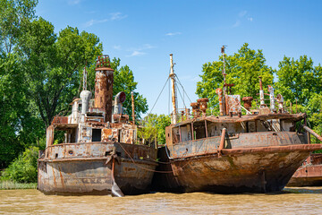 Incredible and beautiful old boats stranded at the edge of a river