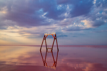 Fototapeta premium Swing in the pink salt lake Sivash. A place in Ukraine for treatment and walks.