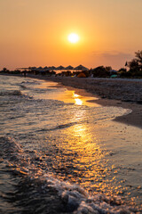 Sunset on the beach on the island Dzharylgach