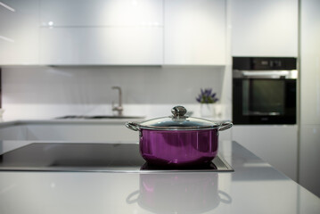 Naklejka na ściany i meble modern kitchen with a metal pot in foreground