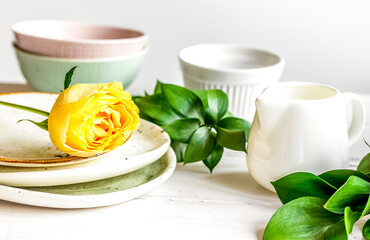 ceramic tableware with flowers on white background