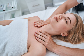 Fototapeta na wymiar Patient having her shoulders massaged during the acupressure treatment