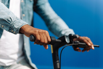 closeup steering wheel of an electric scooter man rides outdoors
