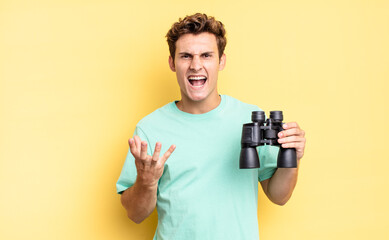 looking angry, annoyed and frustrated screaming wtf or what’s wrong with you. binoculars concept