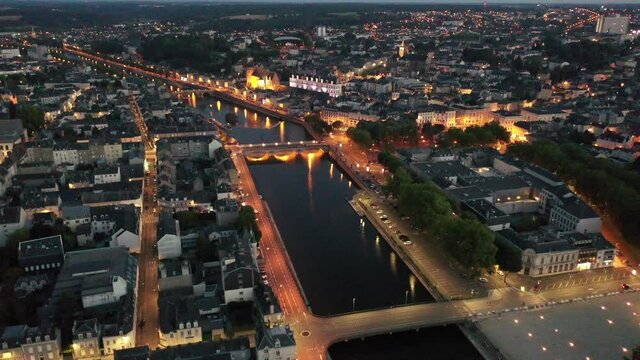 Evening aerial view of Laval with buildings, river Mayenne and old bridge, Mayenne department, north-western France. High quality 4k footage
