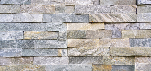 Stone wall texture background of grey brick stones