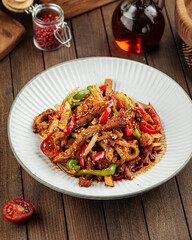 Asian cuisine roasted meat with peppers and sesame seeds