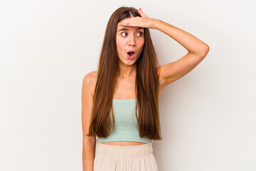 Young caucasian woman isolated on white background looking far away keeping hand on forehead.