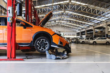 Fototapeta premium car in automobile repair service center with soft-focus and over light in the background