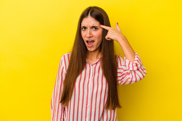 Young caucasian woman isolated on yellow background showing a disappointment gesture with...