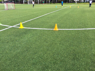 training of athletes on a football field with artificial turf