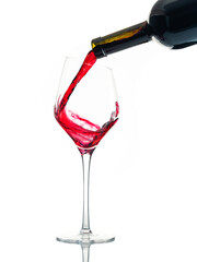 pouring red wine into a glass with beveled edge and splash on white background