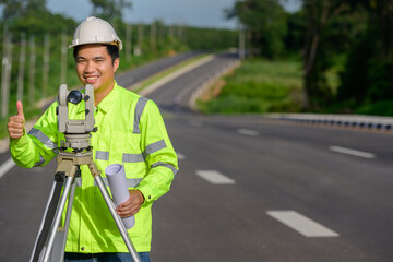 Pictures of civil engineers doing survey work The theodolite was used to measure the land coordinates. Standing at an outdoor theodolite at a construction site on the road.