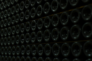 Bottles in the wine cellar. Collector's wine. Winemaking. The best wine in the world. Aged wine. Dust on the bottles.