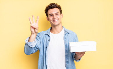 smiling and looking friendly, showing number three or third with hand forward, counting down. white...