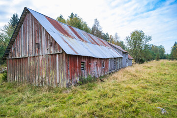 Old abandoned barn on a meadow