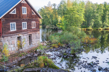 Fototapeta na wymiar Mill by a river in the forest