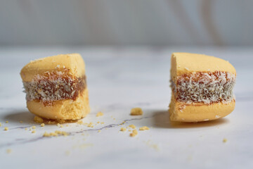 Traditional Argentinian alfajores with dulce de leche on marble table. Argentine gastronomy concept.