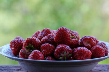 Plate with fresh and juicy strawberries