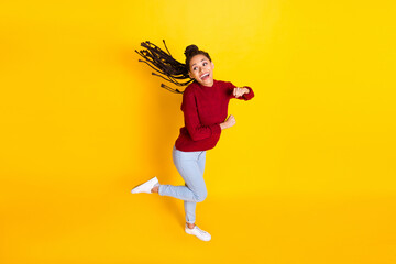 Fototapeta na wymiar Full length high of charming pretty dark skin woman dressed red sweater dancing smiling isolated yellow color background