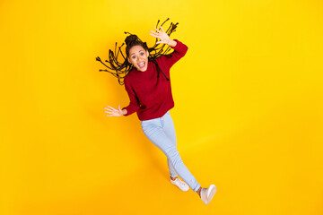 Fototapeta na wymiar Full length high angle photo of funny charming dark skin woman dressed red sweater dancing smiling isolated yellow color background