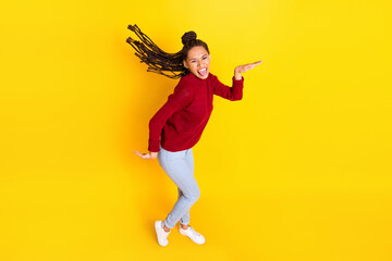 Fototapeta na wymiar Full length photo of pretty funny dark skin woman dressed red sweater dancing smiling isolated yellow color background
