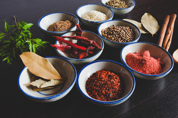 Different spices and herbs in small bowl for cooking Thai food on background.