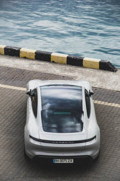 Odessa, Ukraine - September 5, 2021: Electric car Porsche Taycan on the background of the sea