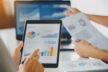 Two businessman investment consultant analyzing company annual financial report balance sheet statement working with documents graphs. Concept of economy, marketing and business corporation.