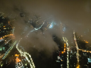 night streets and the bay of the city center through the clouds from a bird's eye view.
