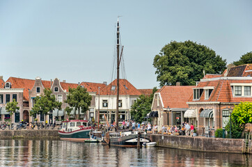 Blokzijl, The Netherlands, August 12, 2021: quays in the old town full of tourists on a sunny day in August