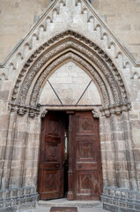 Fototapeta na wymiar View of the door of an old roman catholic church
