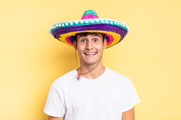 looking happy and pleasantly surprised, excited with a fascinated and shocked expression. mexican...