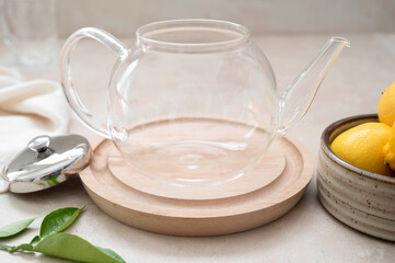 Fototapeta na wymiar Empty glass teapot for tea with lemons and mint.