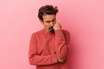 Fototapeta na wymiar Young caucasian man isolated on pink background who feels sad and pensive, looking at copy space.