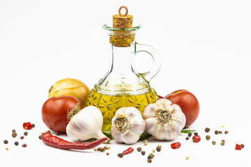 Bottle of olive oil, fresh vegetables, mixed peppers isolated on white background.