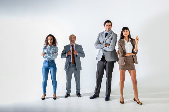 The businesspeople standing on the white wall background group of successful business people isolated on white.