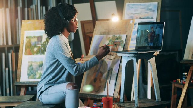 African-american woman is having a remote painting class
