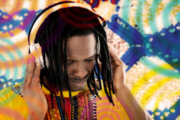 Portrait of a Disc Jockey (DJ) listening to reggae music, dreadlocks, audio headset, colored...