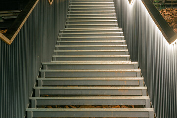 Beautifully illuminated stainless steel staircase leading upwards