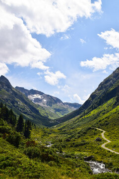 Hiking through a small river vally in Austria under blue sky