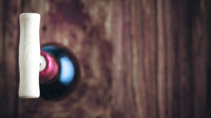 Wine bottle and wine opener on wood