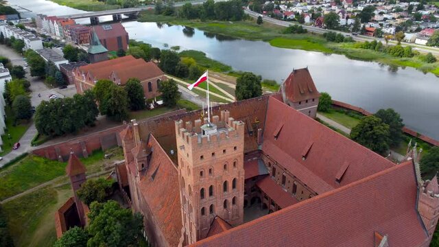 Aerial panning view on Castle fortifications of the Teutonic Order in Malbork from East. Malbork Castle is the largest castle in the world measured by land area.