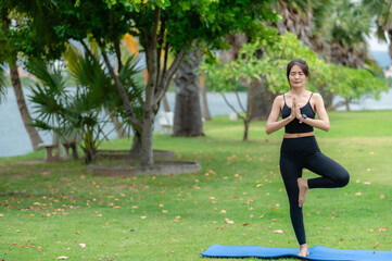 Asian slim woman exercise  alone in the park,Tired from workout,Play yoga concept