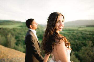 Wedding couple holding hands, groom and bride together on wedding day