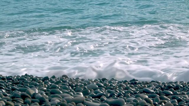 Clean clear waves breaking onto a pebble beach.  Filmed at Looc beach Surigao Philippines