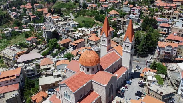 Saint Saba Cathedral At The Center Of A Mountain Village In Bsharri, Lebanon. aerial tilt down
